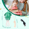 A young girl is interacting with an interactive musical dancing toy featuring a green head and pink tentacles.