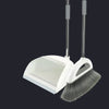 A white broom and dustpan set with a floor wiper tool against a dark background.