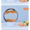 Three different colored hourglass night lights showing blue, orange, and black sandscapes.