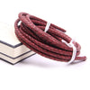 A coil of genuine braided leather cord in a reddish-brown color with white ends.