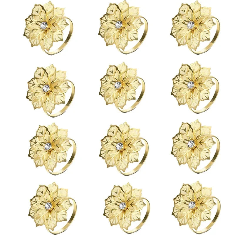 A set of twelve decorative gold metal napkin rings featuring a hollow-out floral pattern.