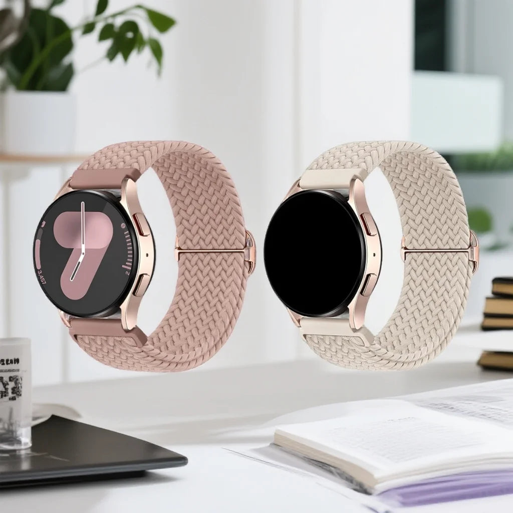 A close-up of a rose gold braided nylon watch band with a black watch face and a matching watch body.