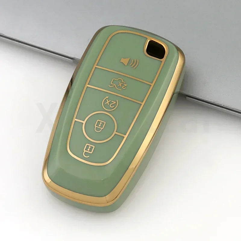 A light green TPU car key fob cover case with multiple buttons and a gold trim, shown from above.
