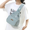 A light blue waterproof nylon crossbody sling bag worn by a woman, featuring a flap closure and strap.