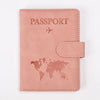 A pink leather passport holder with a world map design and stitching.