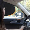A woman is driving a car and looking at the side mirror, with an orange circle highlighting the mirror area.