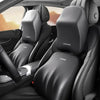 Close-up view of black memory foam car headrests and lumbar support pillows in a vehicle interior.