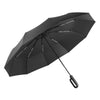 A black fully automatic windproof folding umbrella viewed from above.
