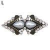Vintage swirl sweater clip featuring a silver-toned oval gemstone surrounded by clear rhinestones.