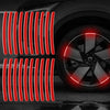 A set of red reflective wheel hub stickers arranged in vertical lines against a dark car wheel.