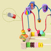 Wooden bead maze roller coaster featuring colorful beads and an abacus counter on a wooden base.