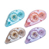 Three double-sided adhesive tape rollers in shades of blue, pink, and purple shown at an angle.