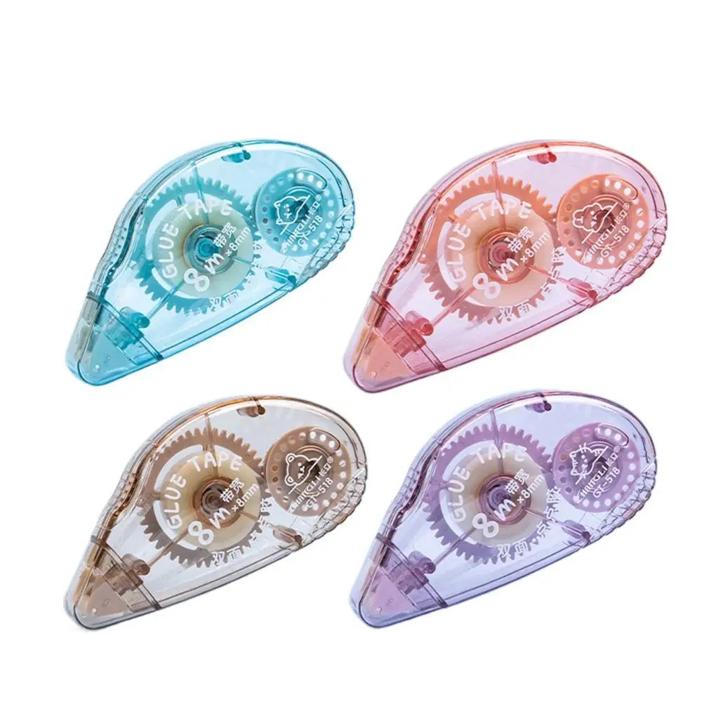 Three double-sided adhesive tape rollers in shades of blue, pink, and purple shown at an angle.