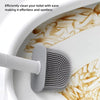 A white silicone toilet brush is shown cleaning a porcelain toilet bowl.