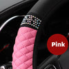 Pink breathable faux leather steering wheel cover with diamond accents on a black steering wheel.