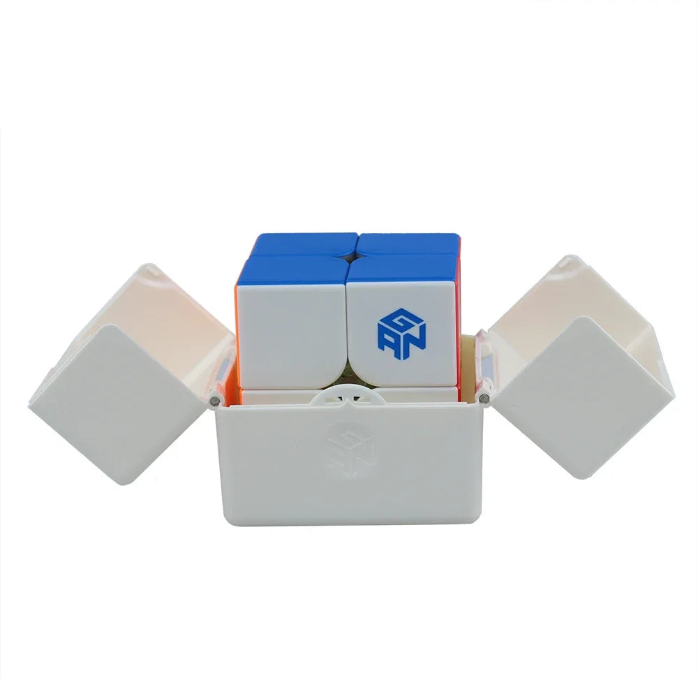 A stickerless GAN 251 M Pro magnetic 2x2 speed cube with blue and white components displayed in its packaging box.
