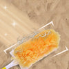 An orange electrostatic duster with cloud wings is shown against a sandy background.