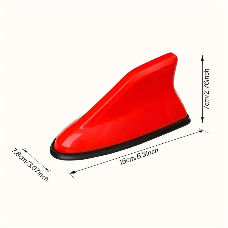 Red aerodynamic shark fin car antenna with signal amplifier shown from the side.