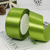 A roll of smooth, light green satin ribbon used for gift wrapping or crafts.