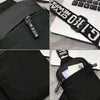 Black canvas chest bag with a zipper closure and a black strap featuring white text