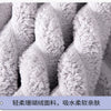 Close-up view of a fluffy gray microfiber towel texture.