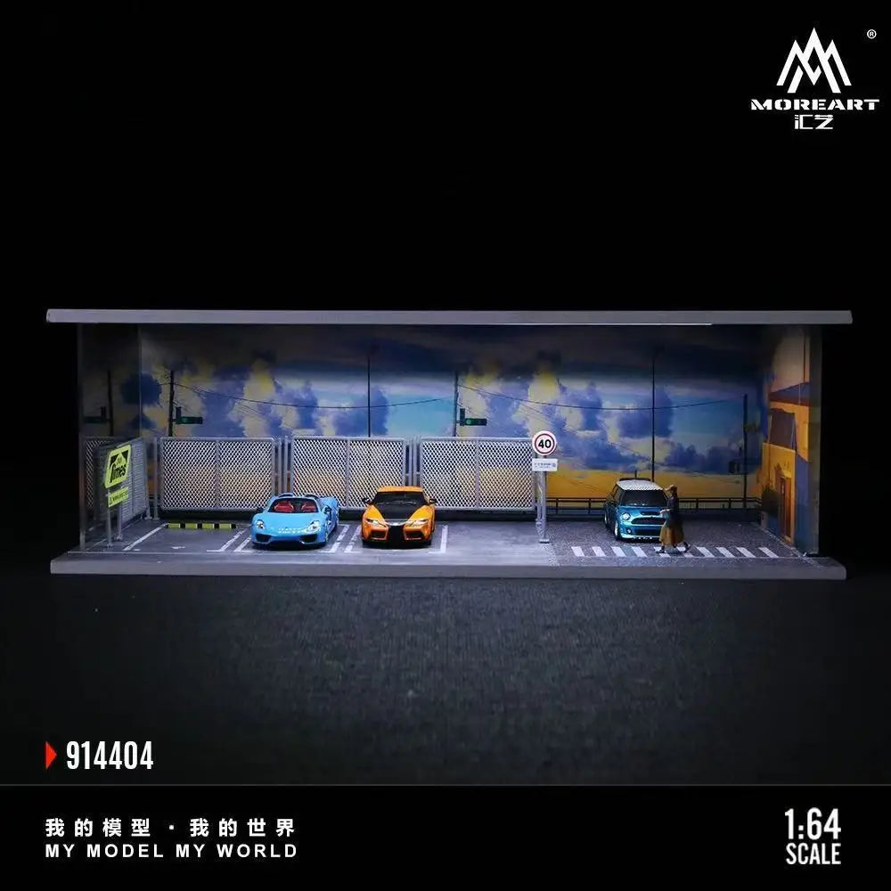 A 1:64 scale miniature garage diorama kit featuring two cars under lighting.