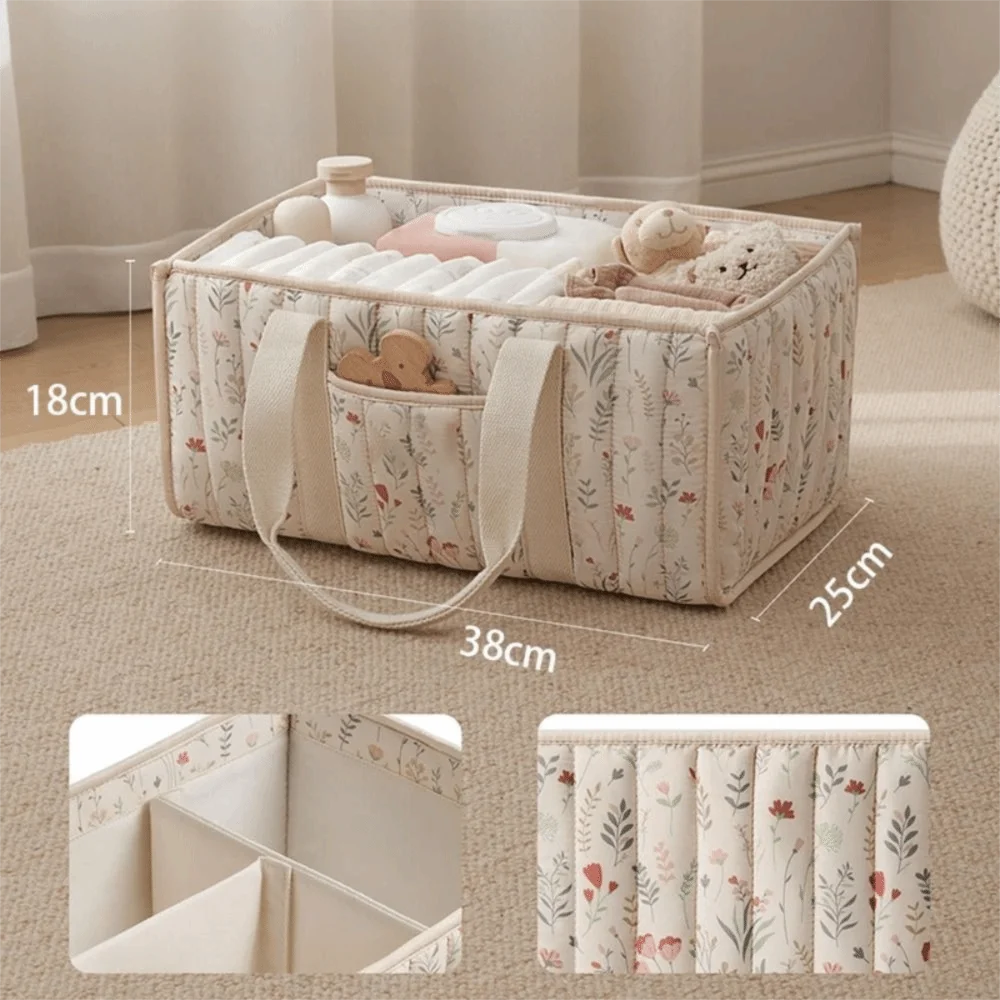 A beige floral diaper organizer bag with multiple compartments and a handle, shown on a light carpet.