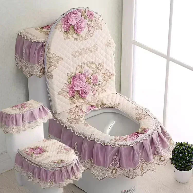 A toilet seat cover set featuring a quilted pink and white cushion with lace trim and purple ruffled skirt.