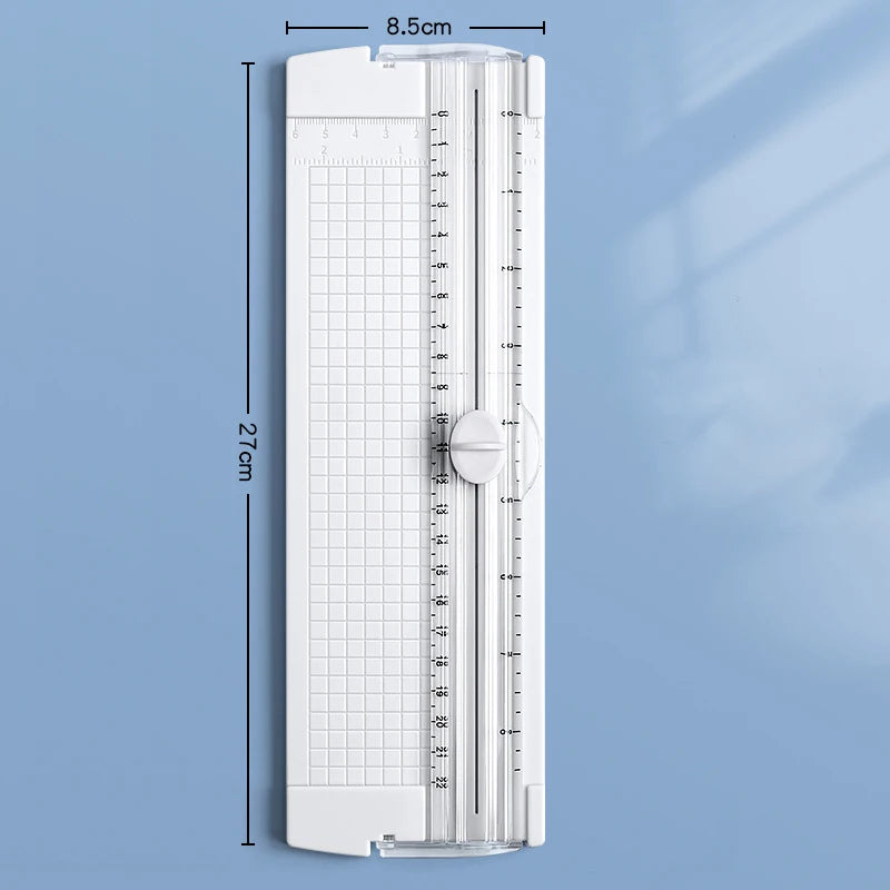 A white A4 mini paper trimmer with a clear plastic guide and ruler markings.