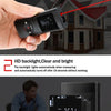 A hand holds a black laser distance measurer device, demonstrating its use for measuring distance to a house.