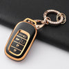 A gold-toned key fob with a black anti-scratch TPU protective case is shown attached to a silver chain.
