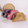 A collection of hand-knit clutch bags in various colors and patterns displayed on a white surface.