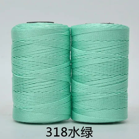 Two spools of light mint green 3-ply polyester knitting yarn for crochet and hand crafts