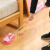 A pink kids broom and dustpan set with an adjustable mop is shown on a wooden floor.