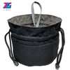 Black velvet dice storage pouch with a gray drawstring and attached metal charms