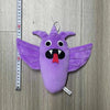 A purple plush toy shaped like a bird with large wings and an open mouth, measured against a ruler.