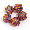 A set of five resin rhinestone beads with a two-tone striped design in shades of purple and orange.