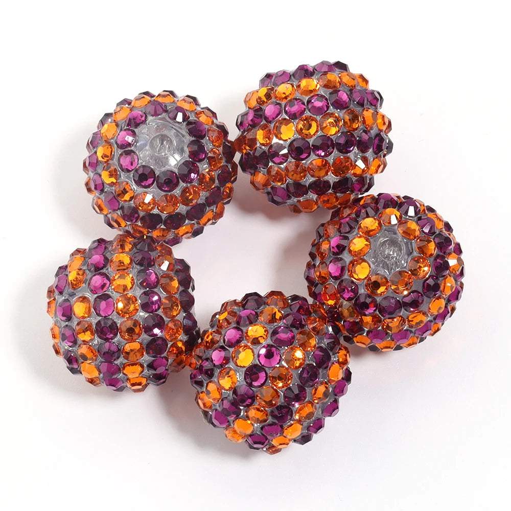 A set of five resin rhinestone beads with a two-tone striped design in shades of purple and orange.