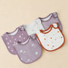 A set of purple and white cotton baby bibs with a U-shaped design are displayed on a light background.