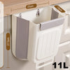 A white foldable hanging trash can with a gray lid and ribbed body is shown mounted on a cabinet.