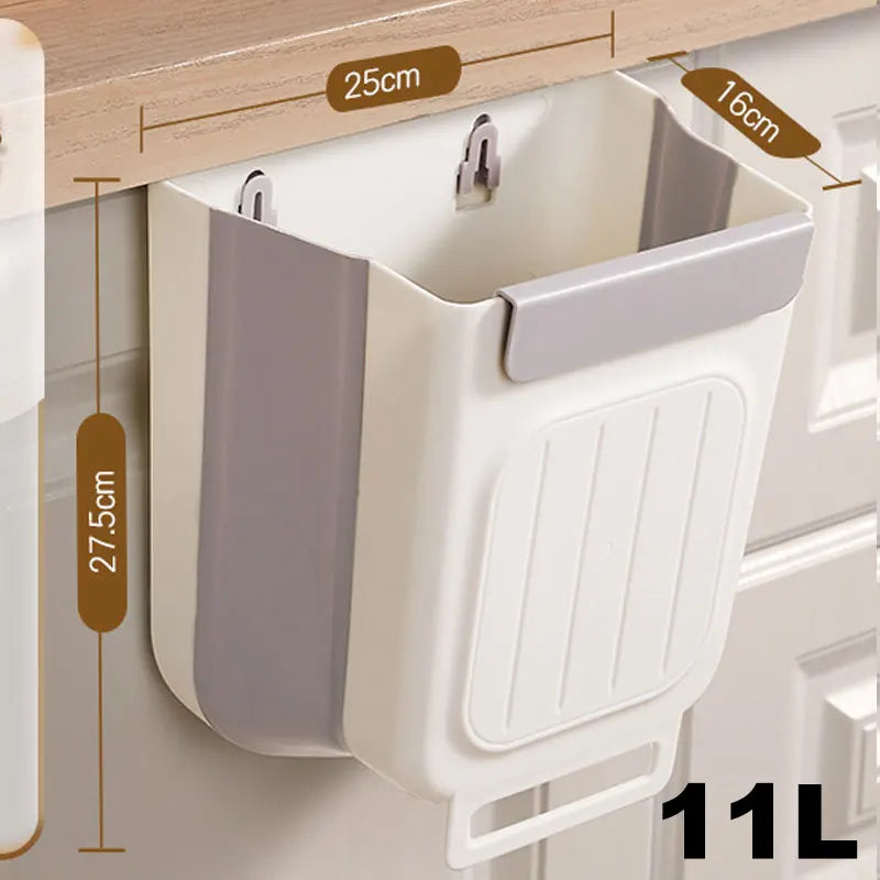 A white foldable hanging trash can with a gray lid and ribbed body is shown mounted on a cabinet.