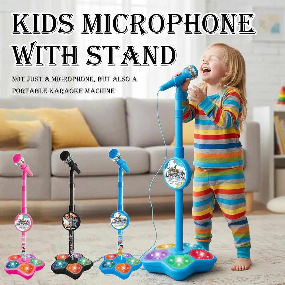 A child is holding a portable karaoke microphone with a stand and light effects on the base.