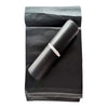 A roll of black self-seal poly mailer bags for shipping placed on a dark background.
