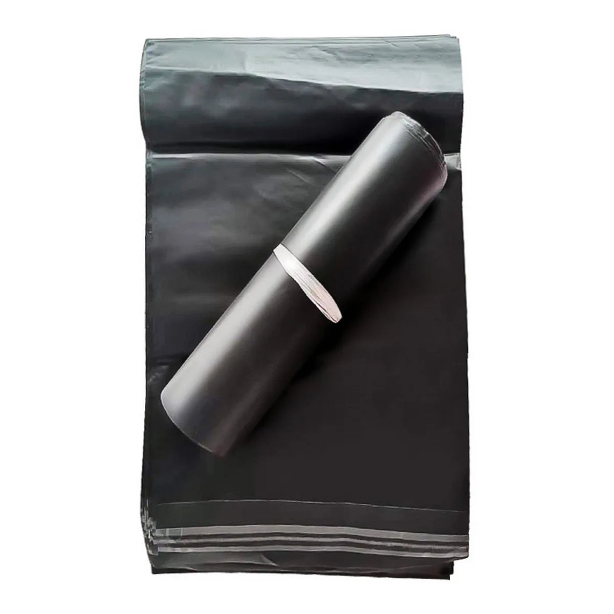 A roll of black self-seal poly mailer bags for shipping placed on a dark background.