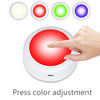 A hand presses a red button on an RGB LED under cabinet light remote control, demonstrating color adjustment.