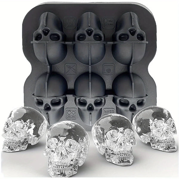 A black silicone ice cube tray with multiple skull-shaped molds and several clear, sculpted ice cubes.