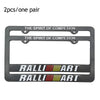 A pair of black racing style license plate frames featuring the text THE SPIRIT OF COMPETITION and RALLYART