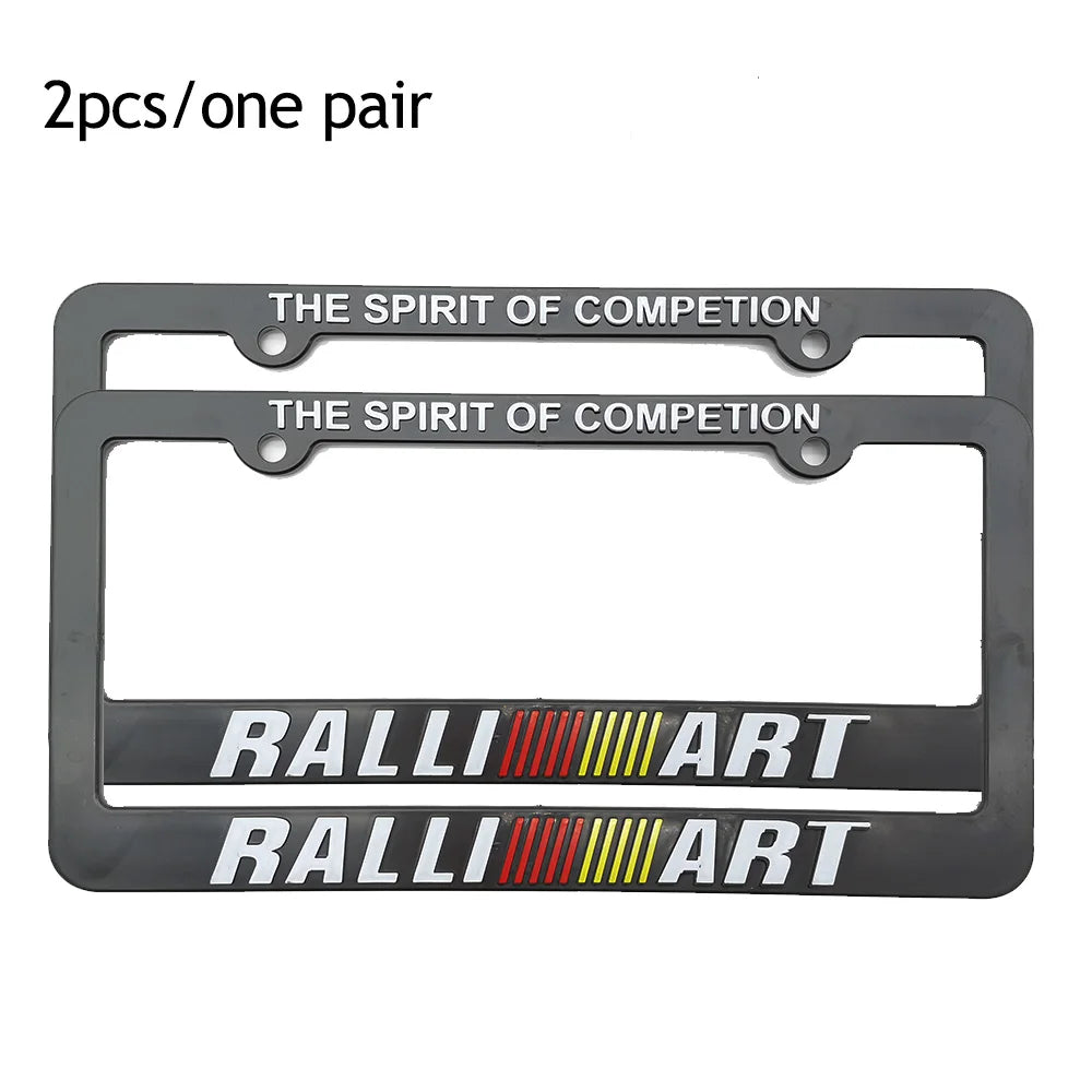 A pair of black racing style license plate frames featuring the text THE SPIRIT OF COMPETITION and RALLYART