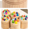 Wooden color sorting toy for toddlers featuring various colored blocks in a wooden container.