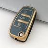 A close-up view of a protective TPU key fob cover for Audi flip keys with gold accents and multiple buttons.
